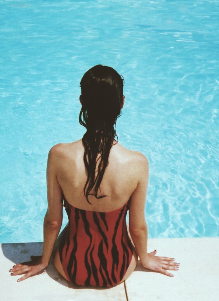 woman sunbathing by pool