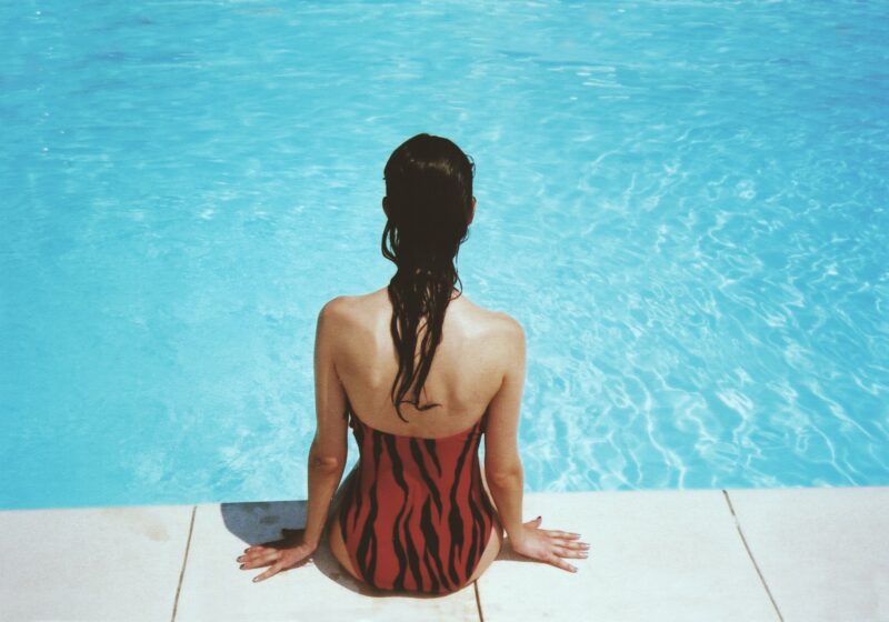 woman sunbathing by pool